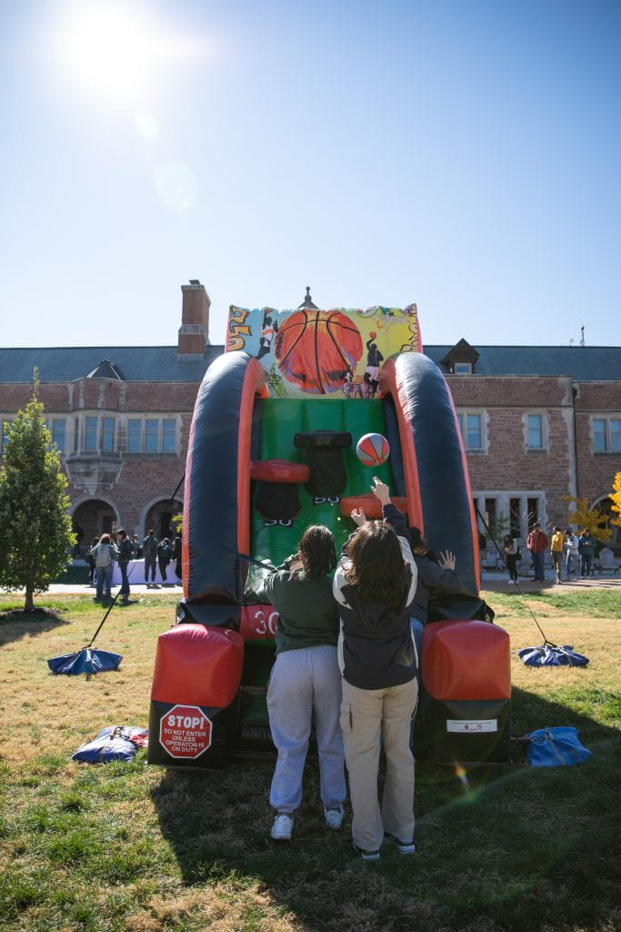 Students play inflatable basketball.